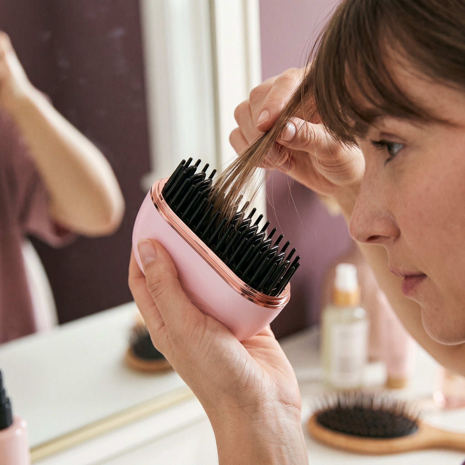 Pink brush smoothing a small dry fringe section