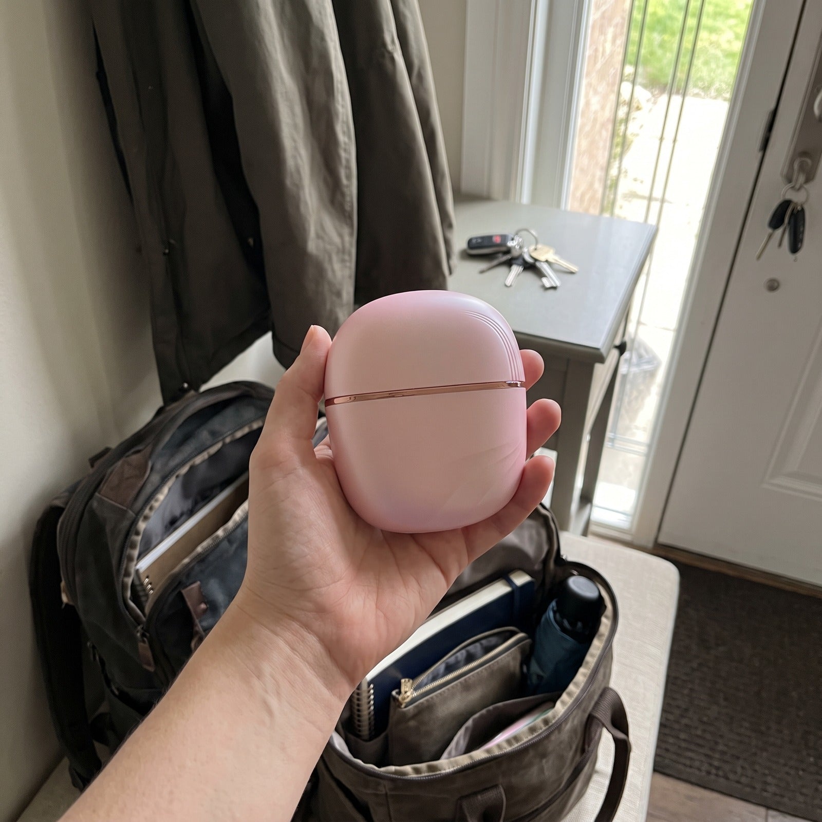 Capped Pink brush above an open commute bag