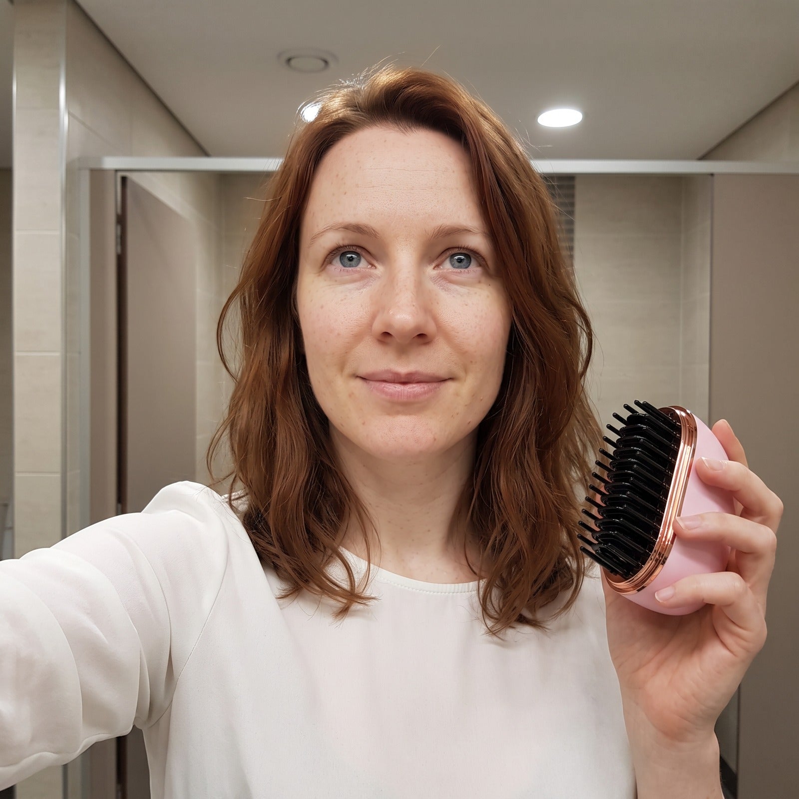 Woman taking a work washroom selfie